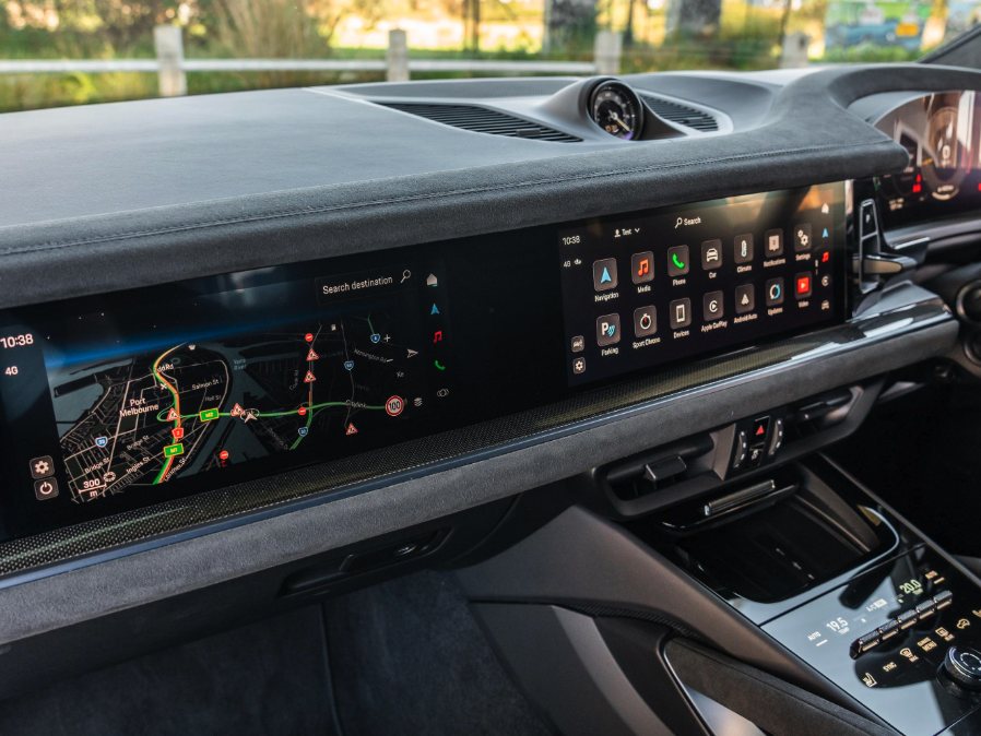 Piano black dashboard trim running the width of a vehicle interior